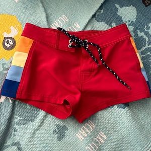 Size 10 Greenlines swim board shorts with adjustable waist and rainbow sides